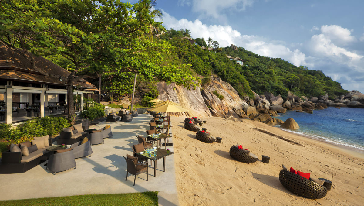 A beachfront lounge and restaurant terrace beneath the hillside villas, Banyan Tree Samui