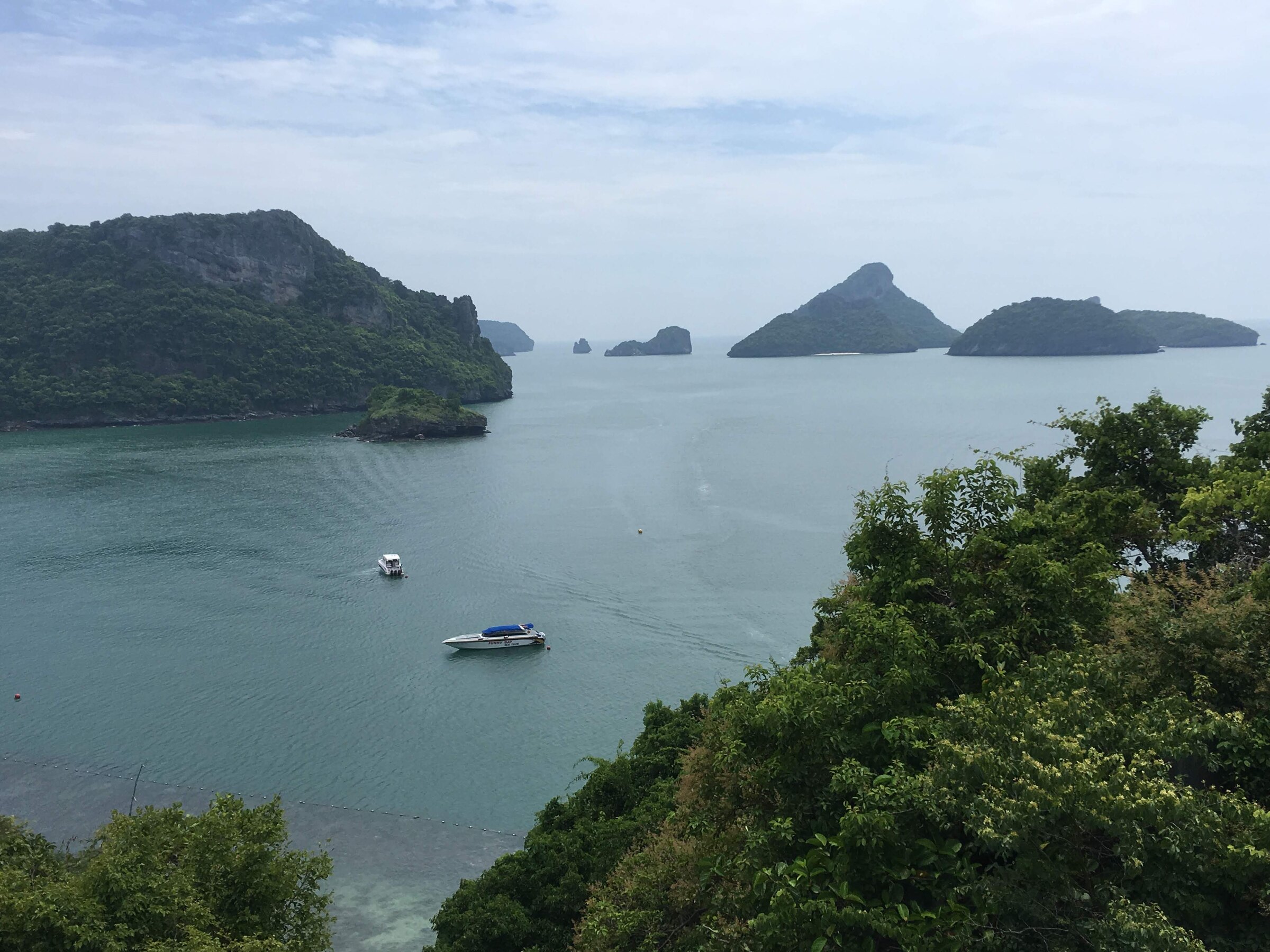 The islands of Ang Thong Marine Park from the Ko Mae Ko viewpoint, a boat moored in the channel below