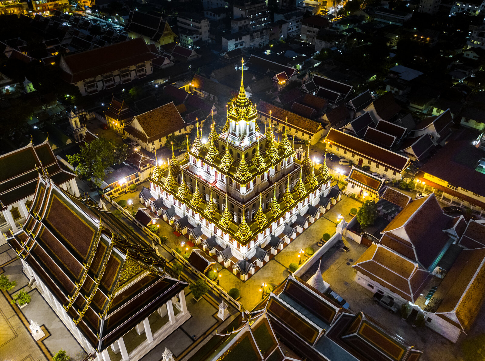 Loha Prasat, the many-spired Metal Castle of Wat Ratchanatdaram, lit at night in Bangkok Old City