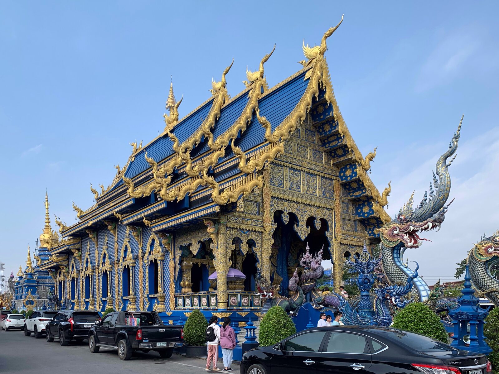The sapphire and gold facade of Wat Rong Suea Ten, the Blue Temple