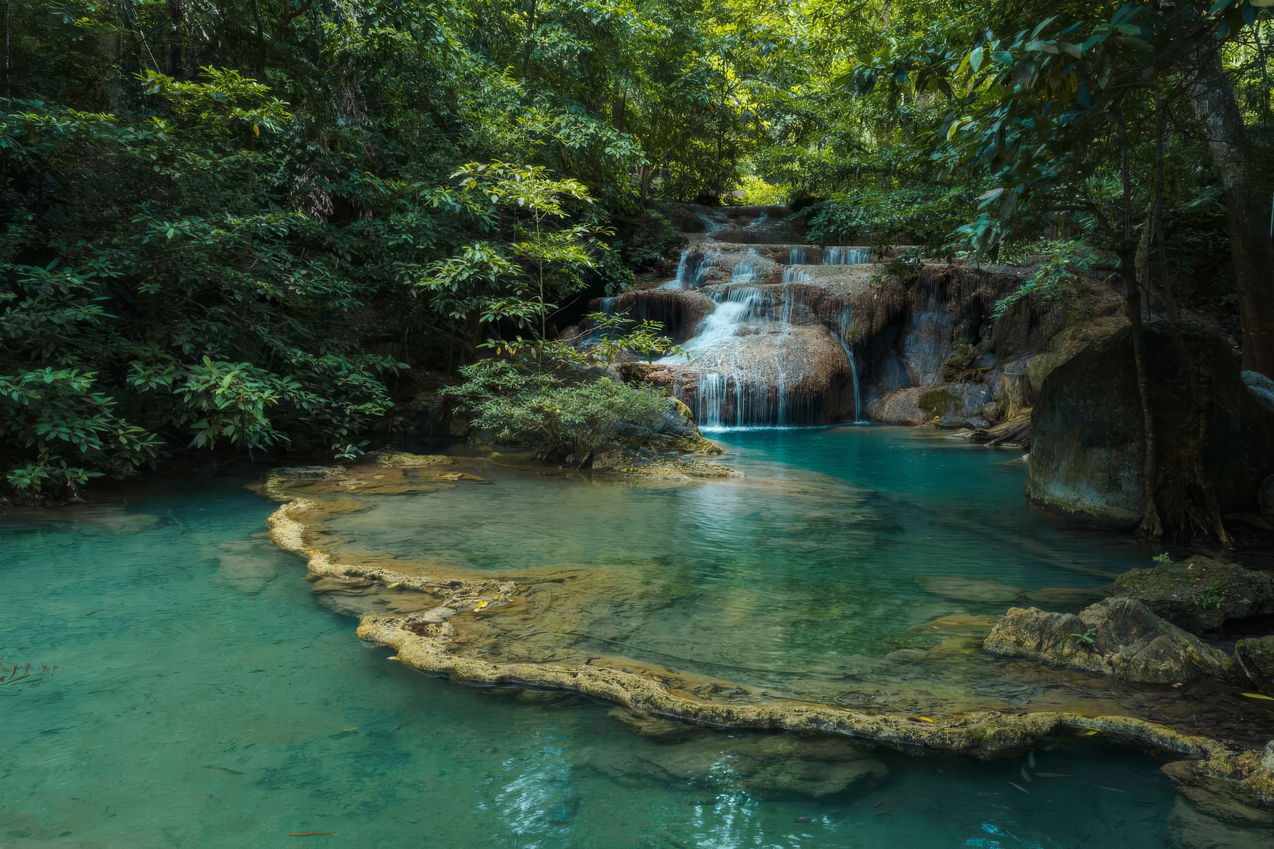 A turquoise limestone pool below one of the tiers of Erawan Falls, Kanchanaburi