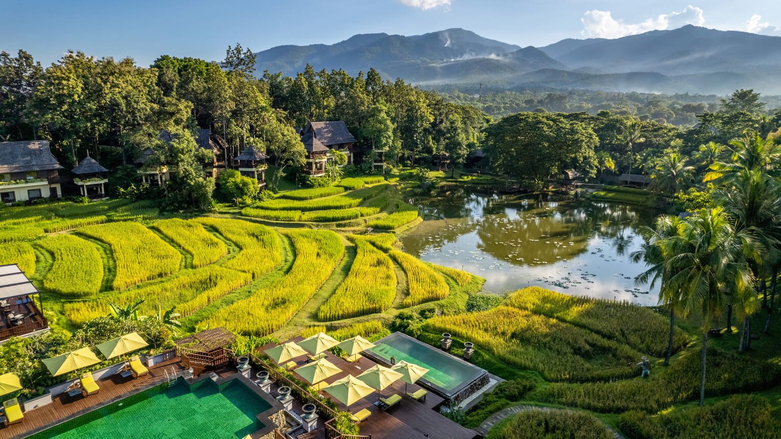 An aerial view of a resort set among rice paddies in the Chiang Mai hills