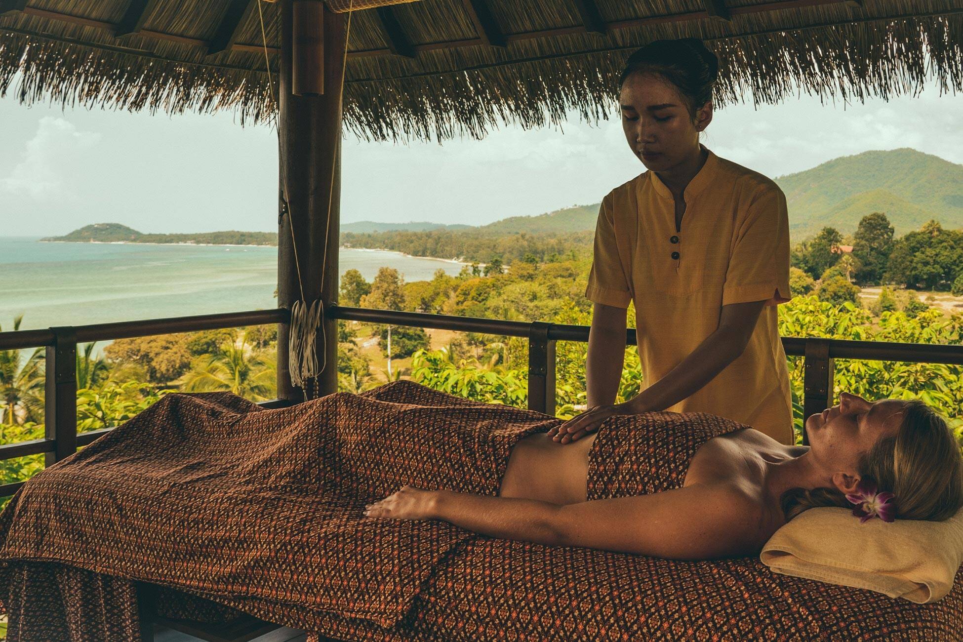 A treatment sala set against a green valley view