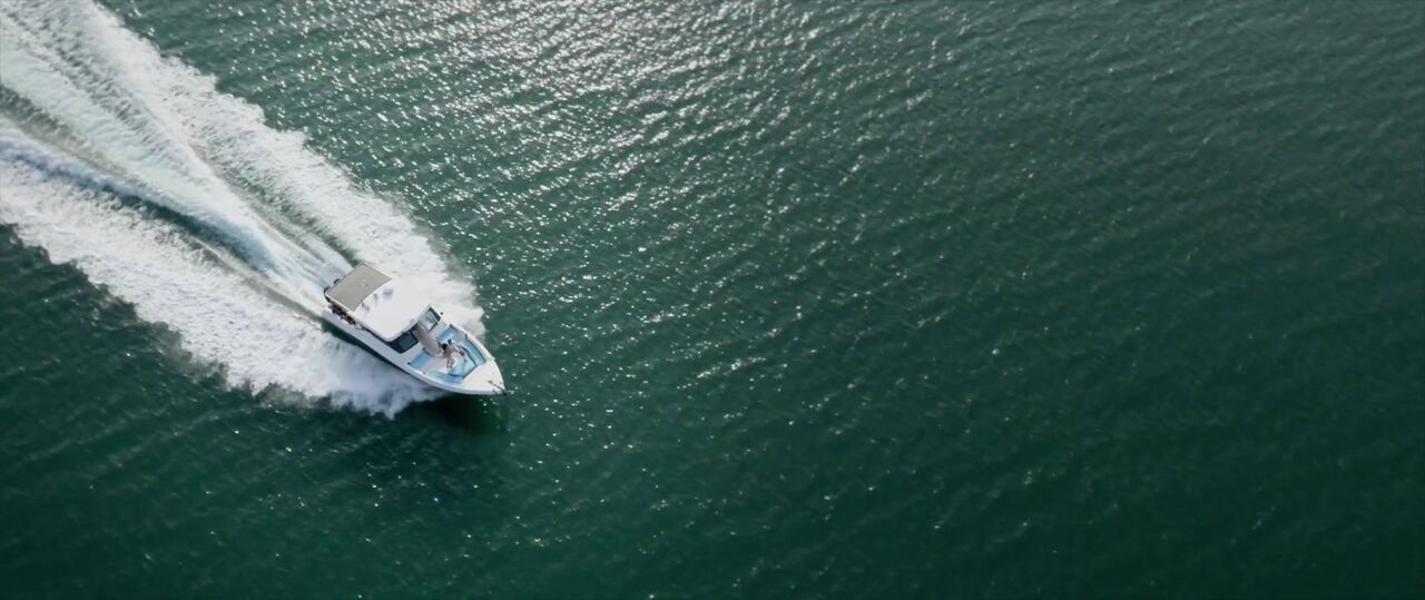 A private motor yacht crossing the emerald waters of southern Thailand